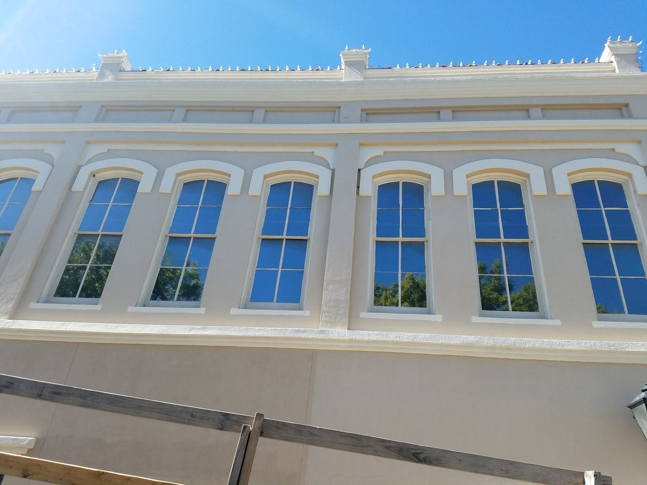 Restored arched upper-floor windows on a downtown Brenham, TX storefront