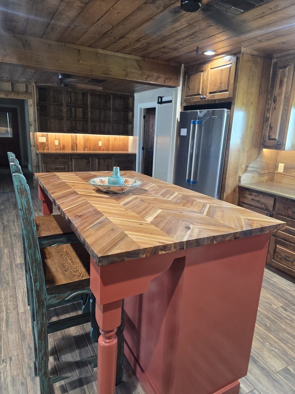 Kitchen with stone slab countertops and wood cabinets in Giddings, TX