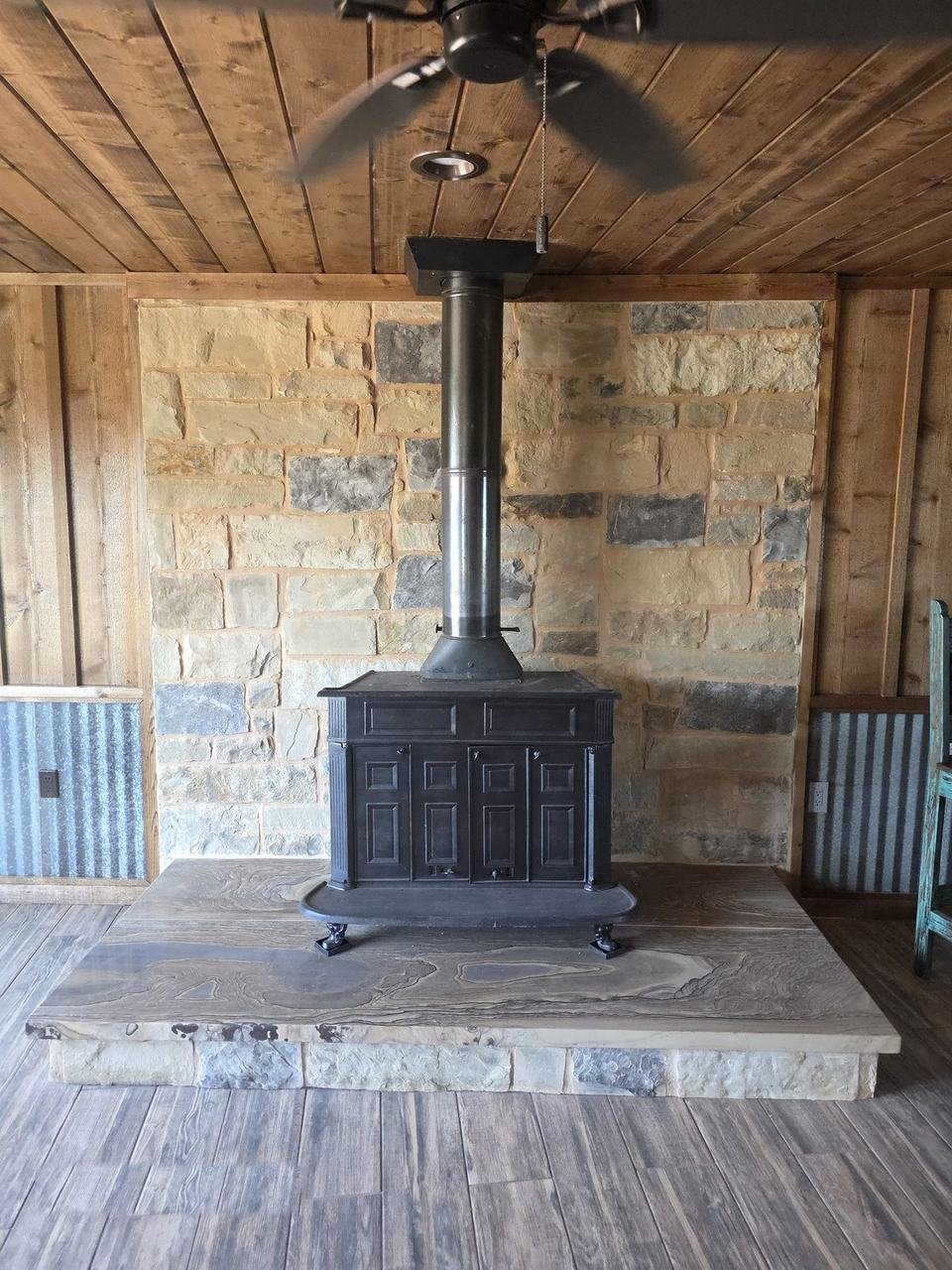 Stone hearth and wood stove installation in a Giddings, TX cabin