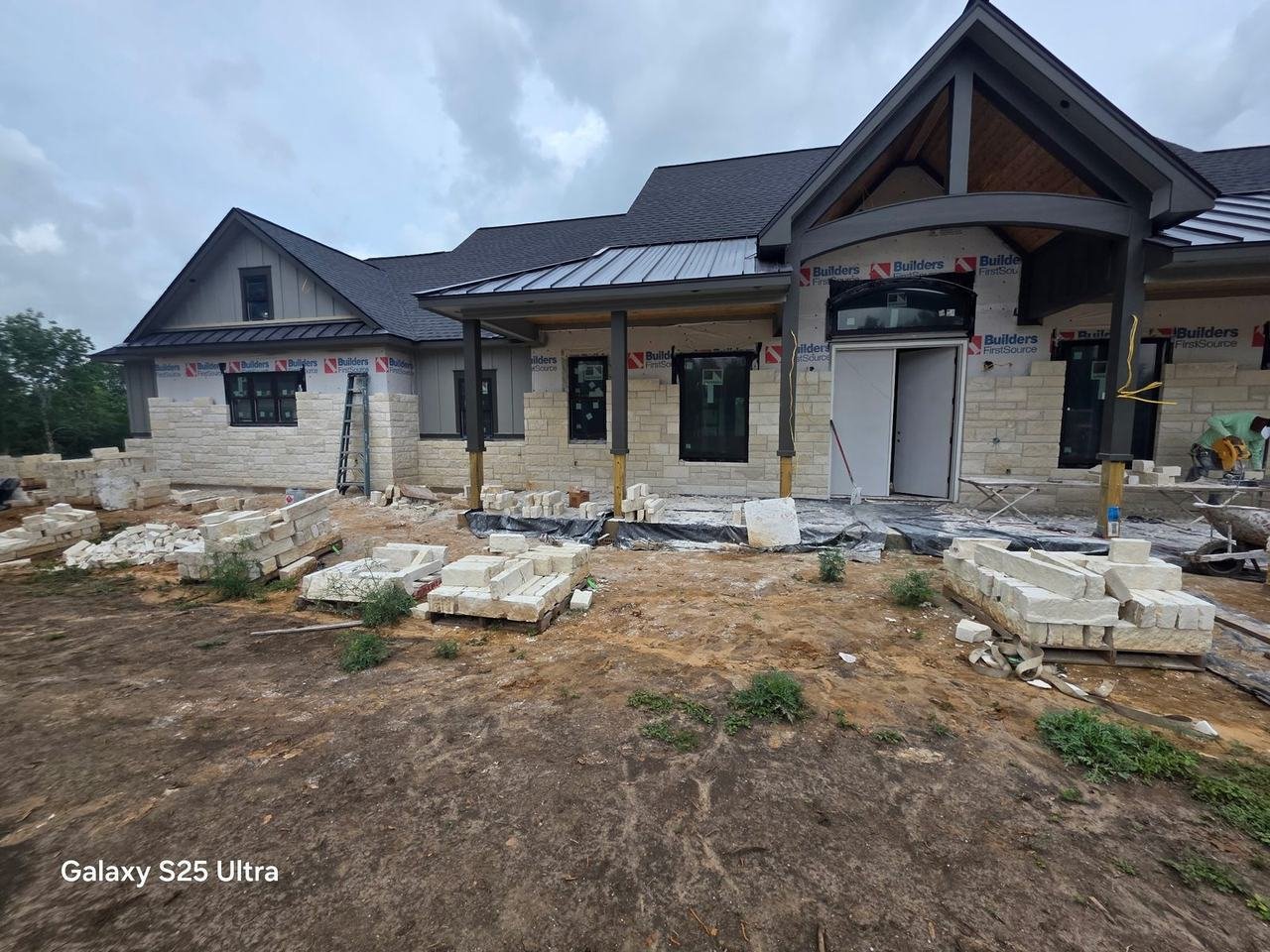 Natural stone being installed on the front of a new home in Chappell Hill, TX