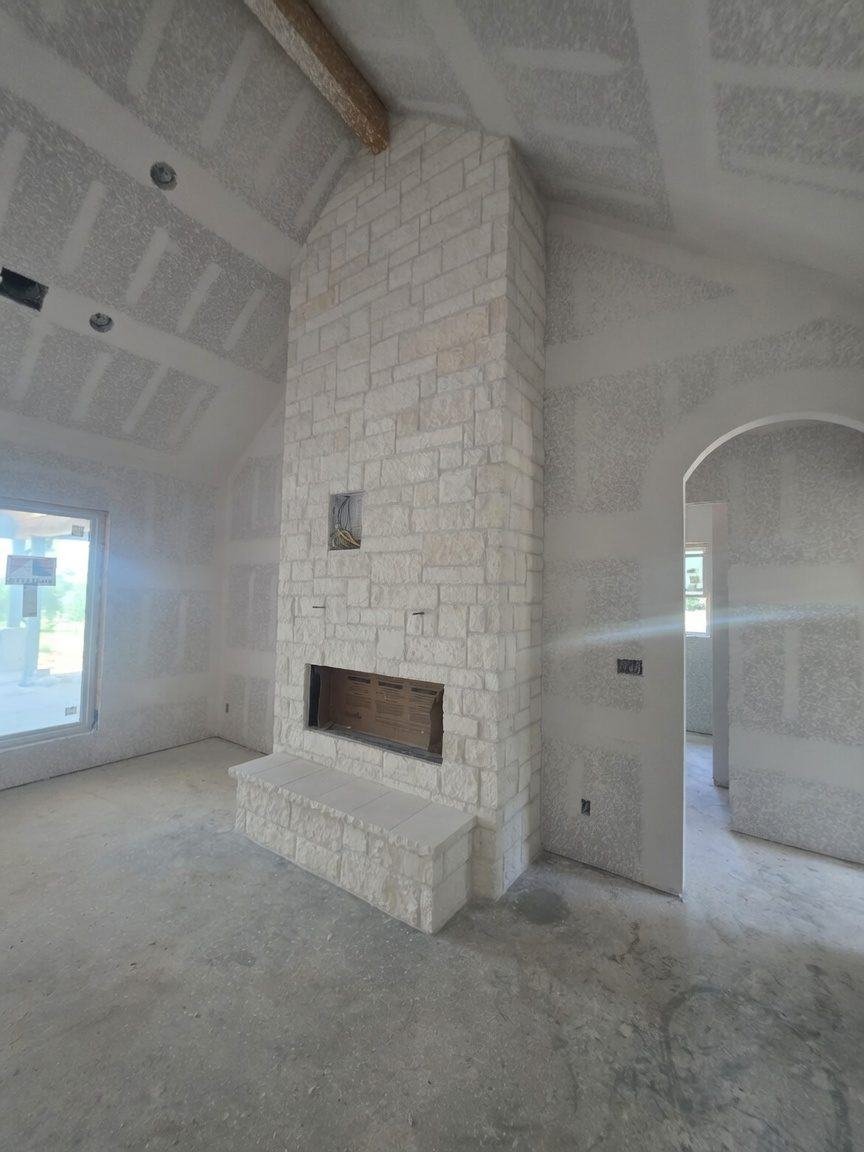 Natural stone fireplace with raised stone hearth bench in Chappell Hill, TX