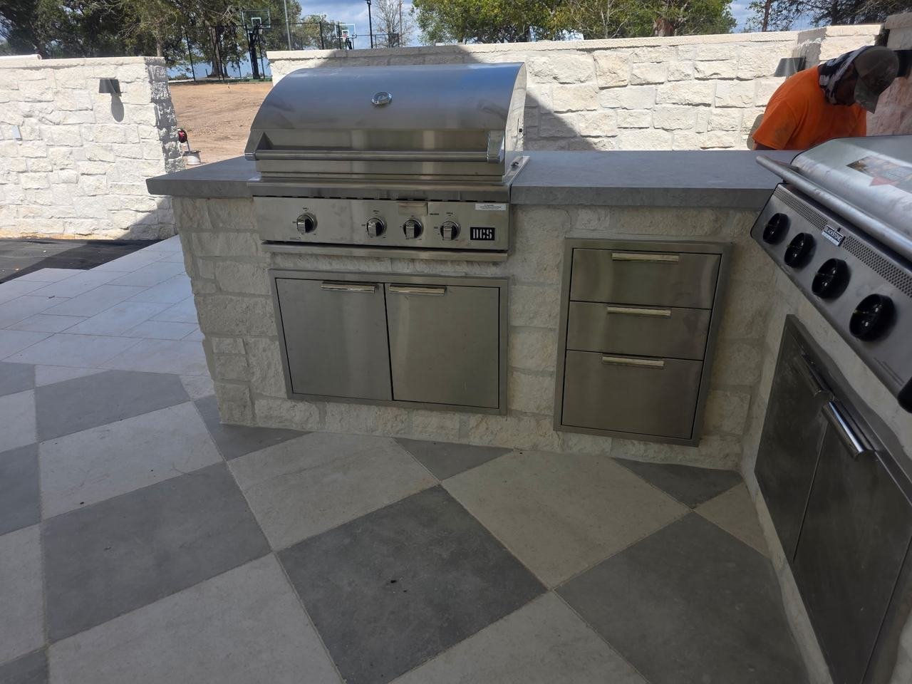 Outdoor kitchen grill station with stone counter in Burton, TX